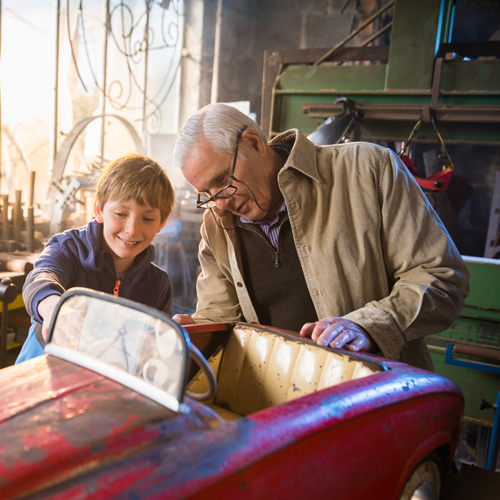 Male and boy repairing car