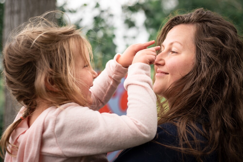 Mother and young daughter outside