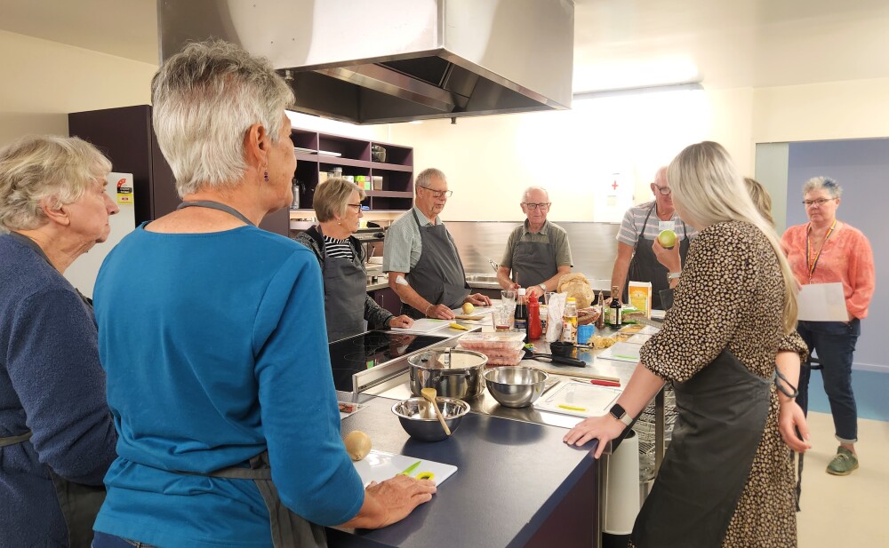 Older adults in kitchen cooking