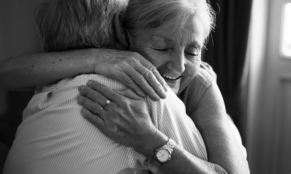 Older women hugging in black and white