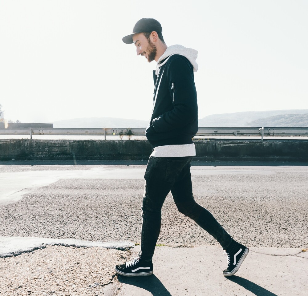 Young male walking outside cropped