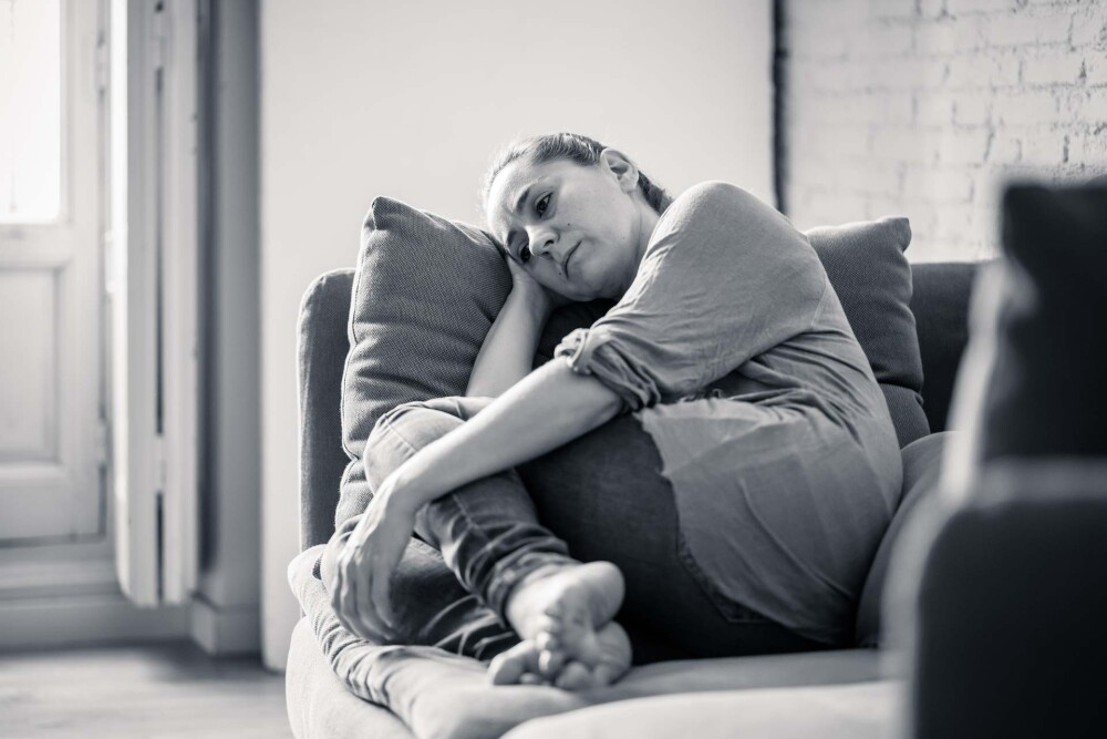 woman on couch sad black and white edited